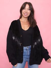 Model wearing 90s vintage black cardigan jacket with knit sleeves and faux suede front

