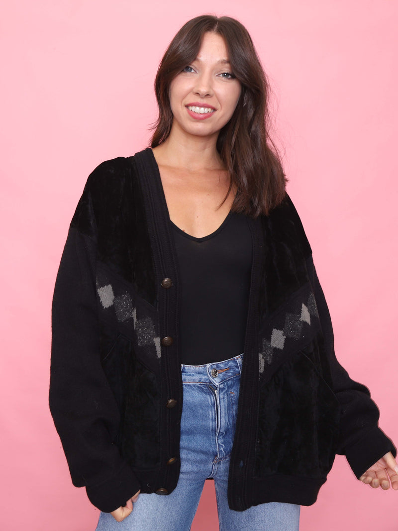 Model wearing 90s vintage black cardigan jacket with knit sleeves and faux suede front

