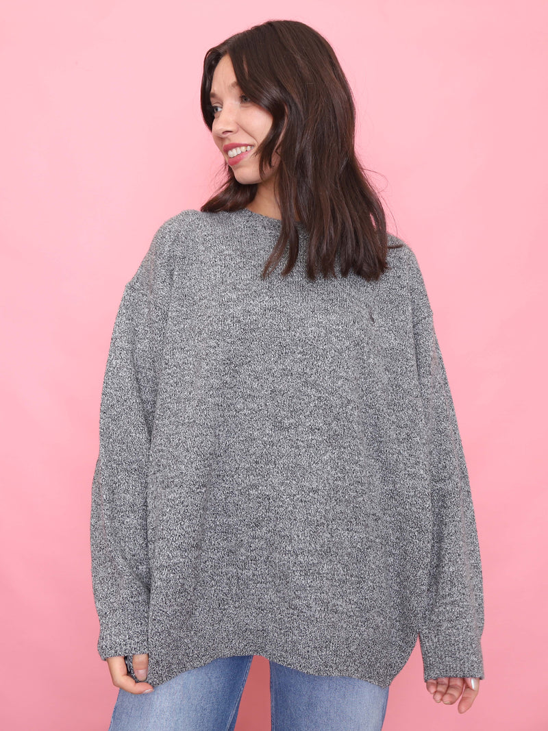 Model wearing an oversized vintage grey jumper with a marled knit texture and relaxed fit.

