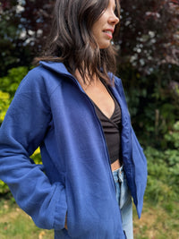 Model wearing a Columbia Interchange full zip fleece jacket in deep blue, standing outdoors