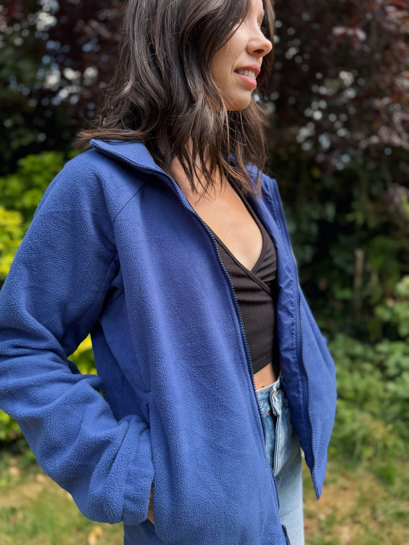 Model wearing a Columbia Interchange full zip fleece jacket in deep blue, standing outdoors