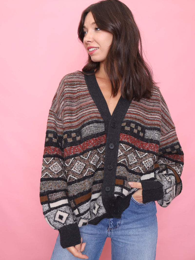 Model wearing a vintage Hugo Boss wool blend cardigan with bold geometric knit patterns and button-up front.