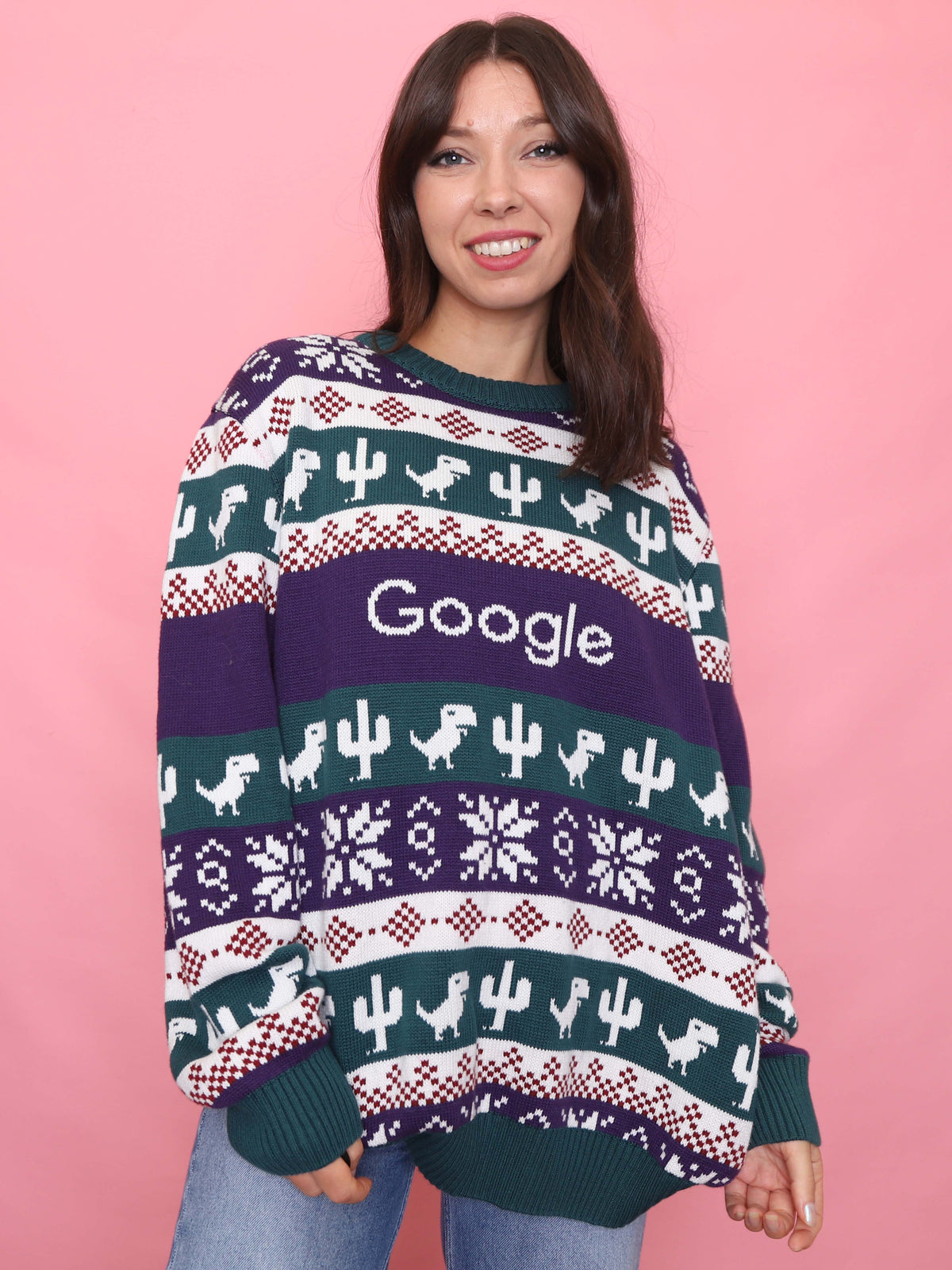 Woman wearing a retro Google Christmas jumper with dinosaur and cactus knit pattern

