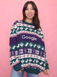 Woman wearing a retro Google Christmas jumper with dinosaur and cactus knit pattern

