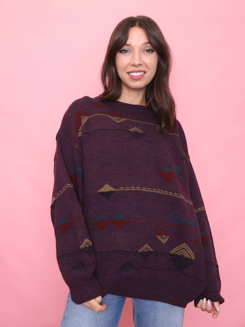 Model wearing a 90s vintage burgundy knit jumper with geometric pattern – oversized unisex retro sweater.