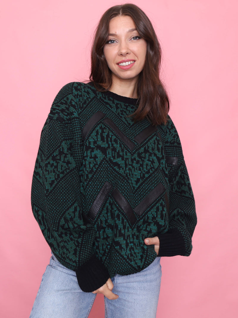 Vintage 80s chevron knit jumper in green and black with leather-look details, model wearing front view