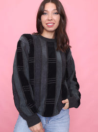 Vintage 90s striped knit jumper in black and charcoal grey, model wearing front view.