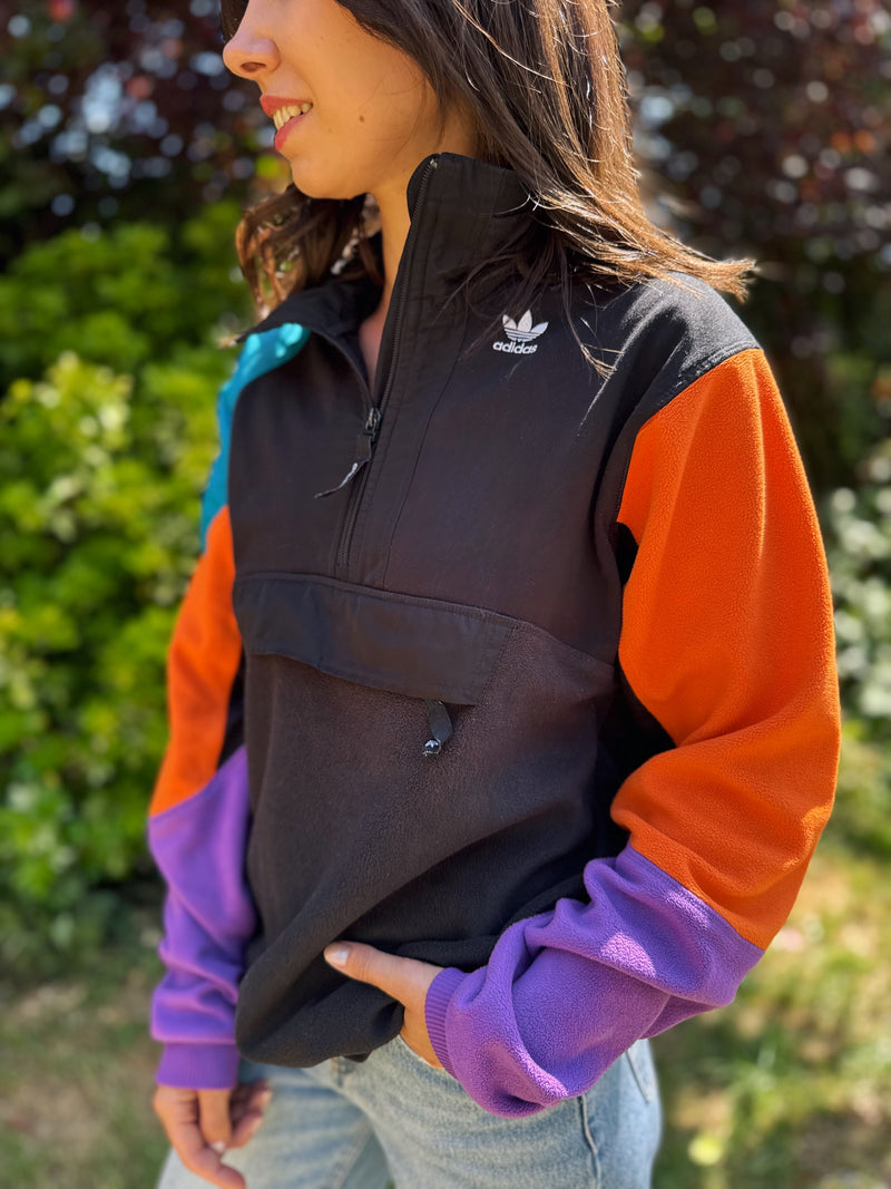 Model wearing vintage Adidas 1/4 zip fleece with multicolour sleeves and trefoil chest logo