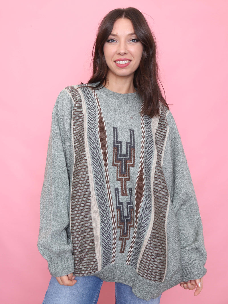 Model wearing a vintage grey jumper with Aztec pattern in brown and navy tones

