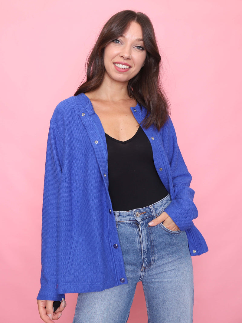 Model wearing a vintage electric blue textured cardigan shirt with snap button front and side pockets.

