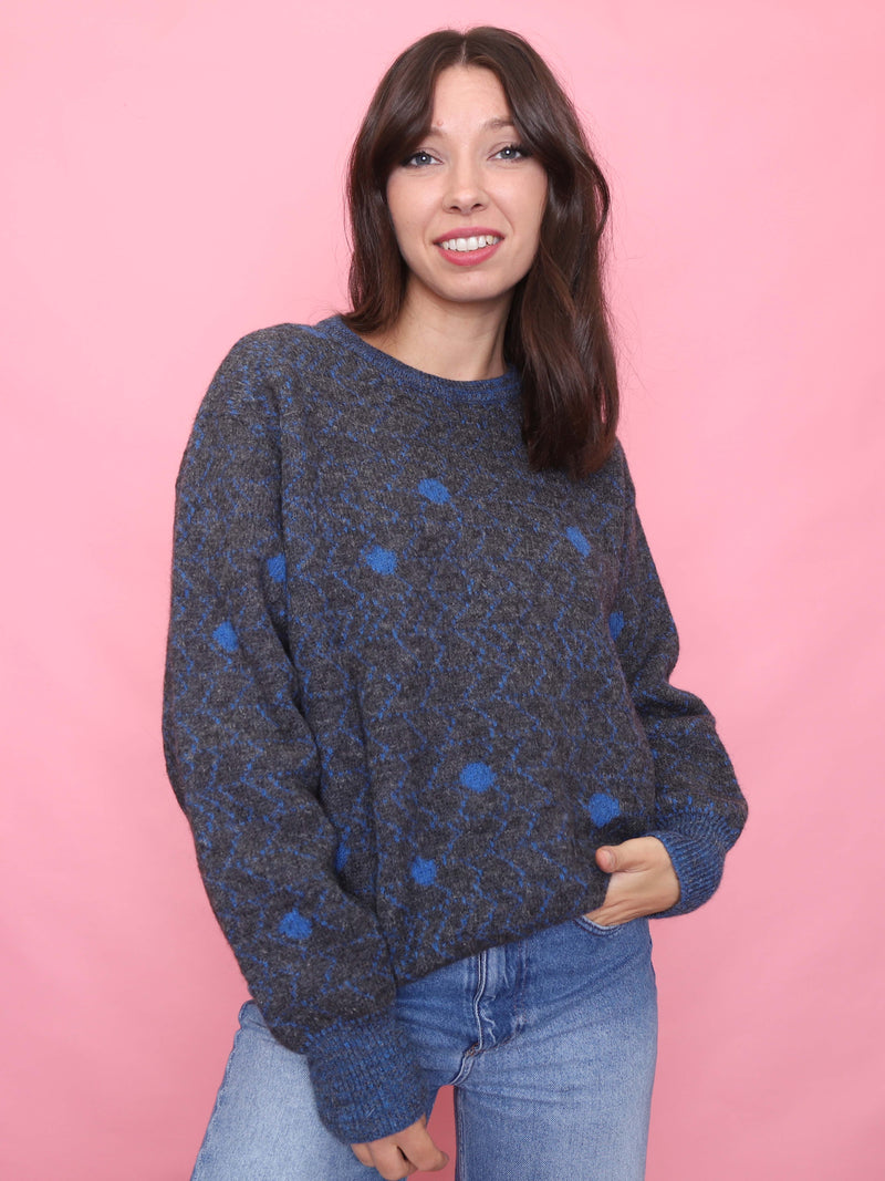 Model wearing vintage navy and blue knit jumper with zigzag and dot pattern, cozy winter sweater aesthetic