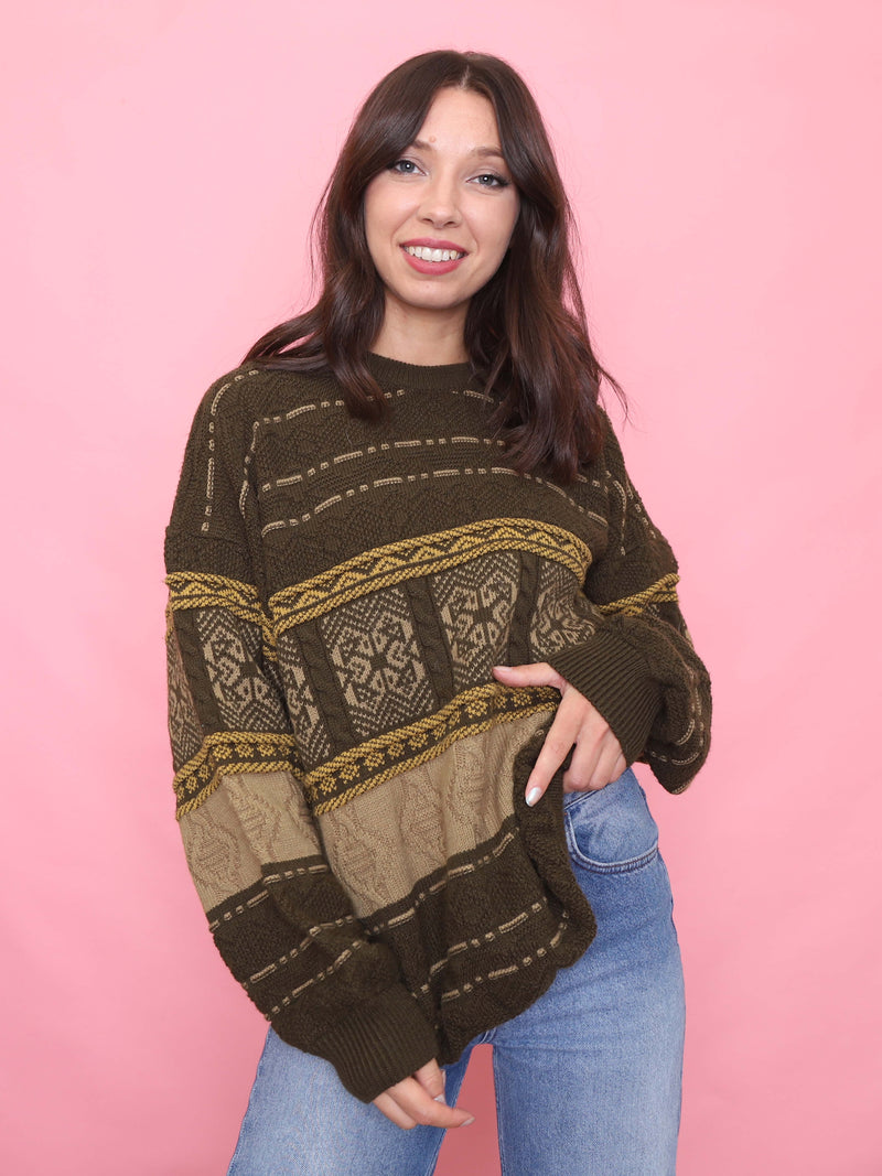 Model wearing a vintage 90s brown and mustard Nordic patterned jumper with a relaxed oversized fit.

