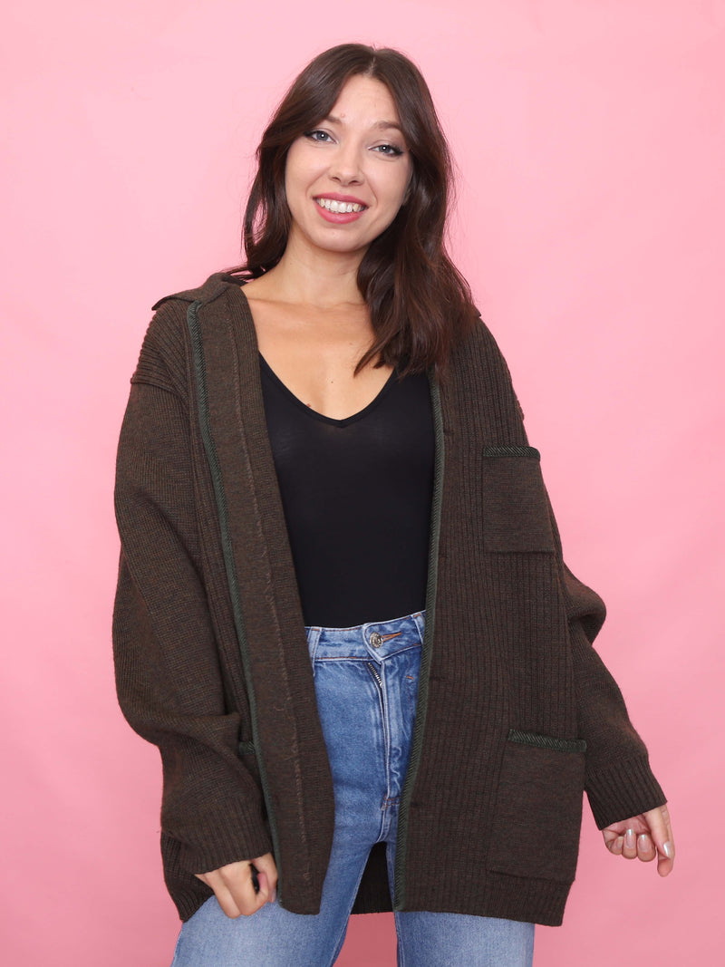 Model wearing a vintage deep brown ribbed knit cardigan with green trim and patch pockets – oversized unisex autumn layering cardigan