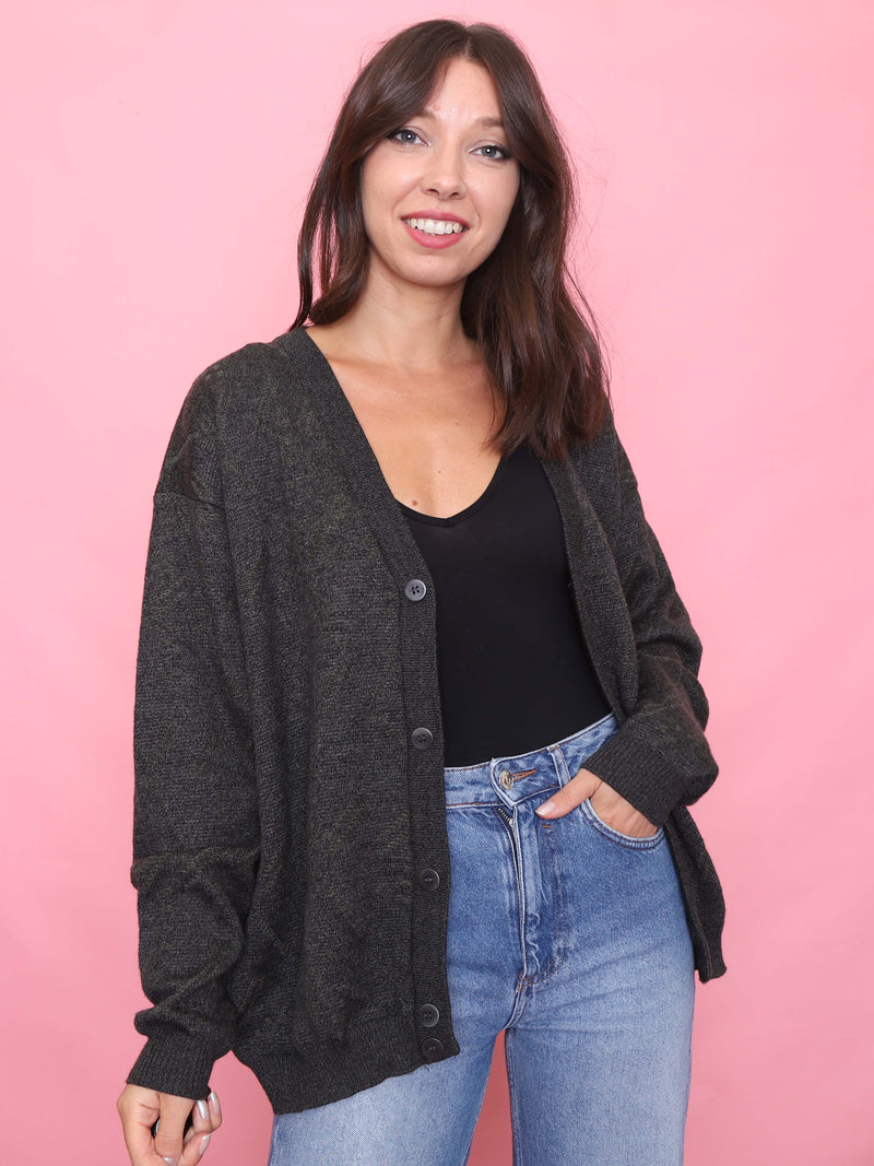 Model wearing a vintage charcoal knit cardigan with button-up front and relaxed unisex fit  perfect for cosy, autumnal layering.