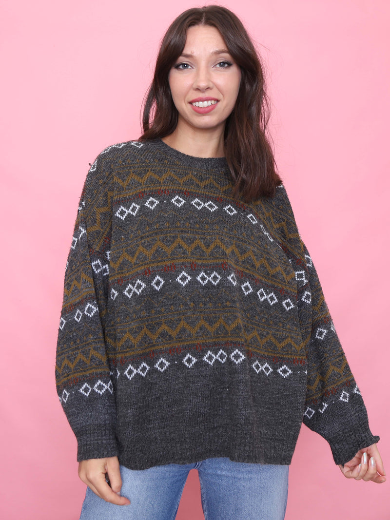 Model wearing a vintage charcoal Fair Isle knit jumper with geometric pattern

