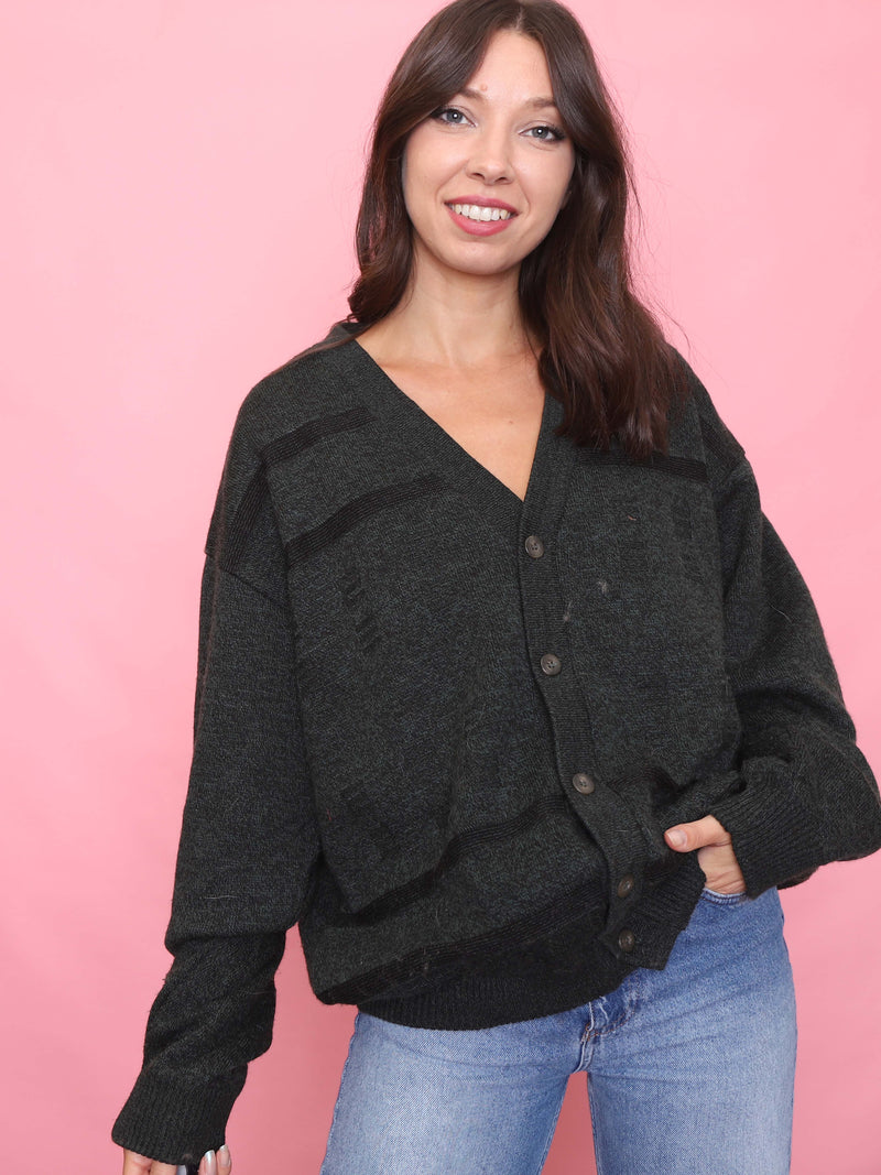 Model wearing vintage dark grey green fully lined cardigan jacket with button-up front

