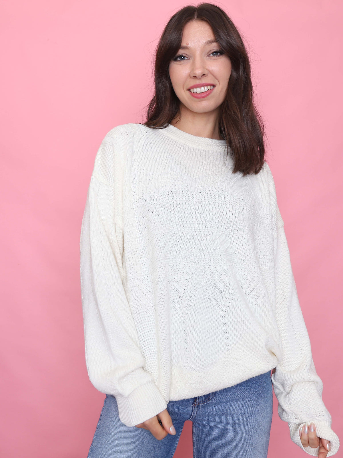 Woman wearing a vintage cream knit jumper with subtle textured geometric pattern and relaxed fit

