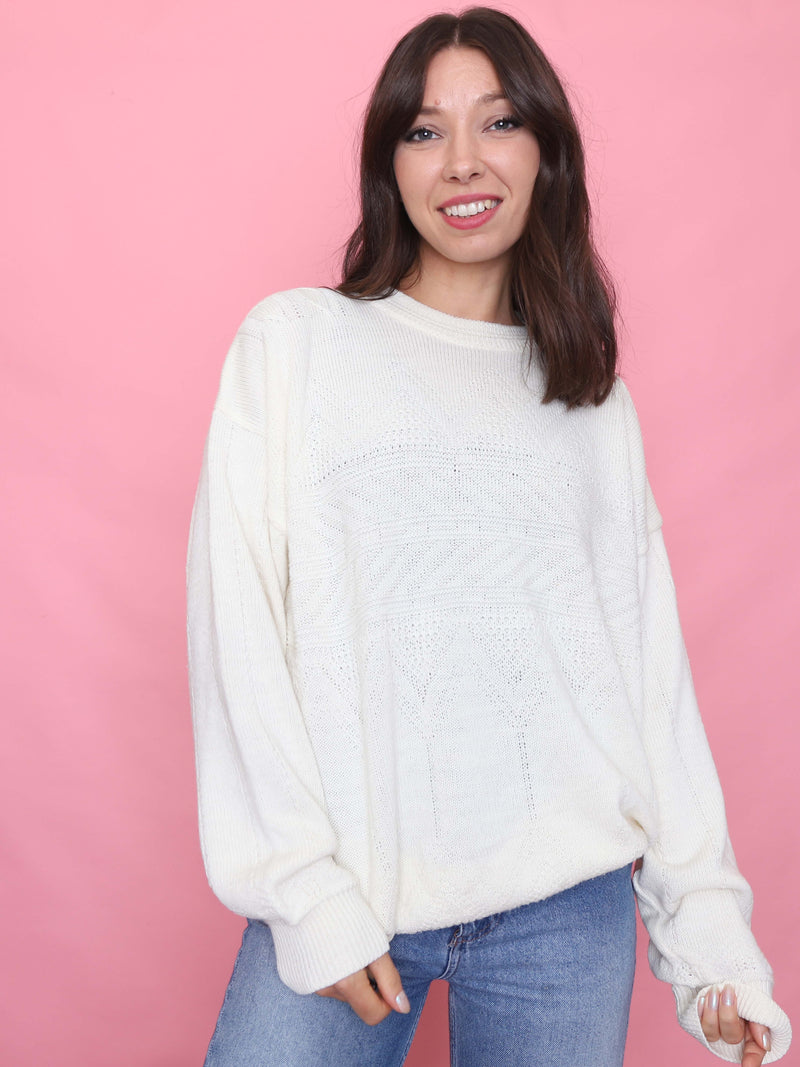 Woman wearing a vintage cream knit jumper with subtle textured geometric pattern and relaxed fit


