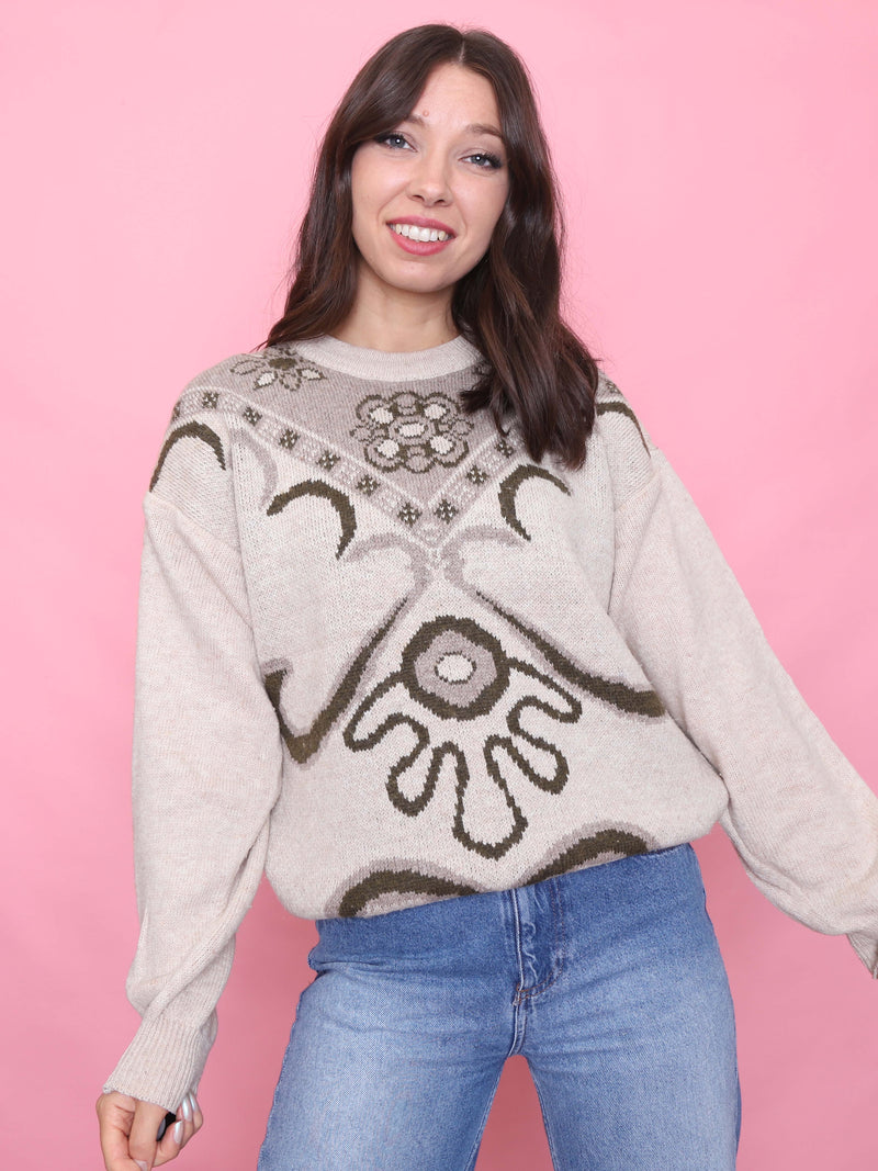 Model wearing a vintage oversized cream jumper with olive green scroll and floral pattern - soft autumn knit aesthetic