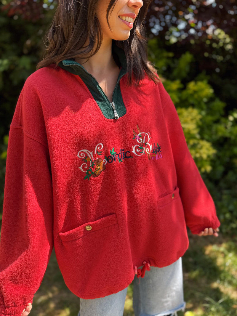 Model wearing vintage FILA red fleece pullover with floral embroidery and green collar

