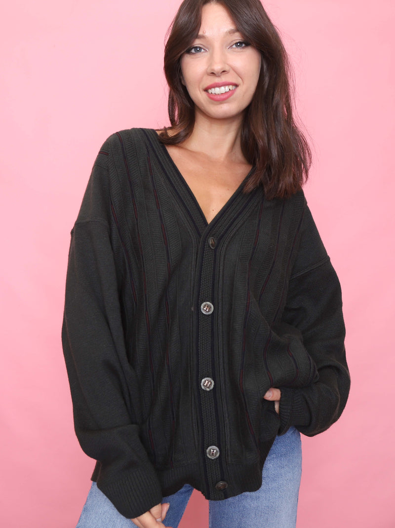 Model wearing a vintage deep olive green knit cardigan with burgundy pinstripe detail, button-up front, and relaxed fit.