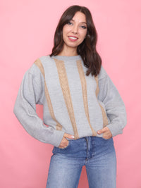 Model wearing a grey vintage jumper with beige vertical cable knit details and relaxed unisex fit.

