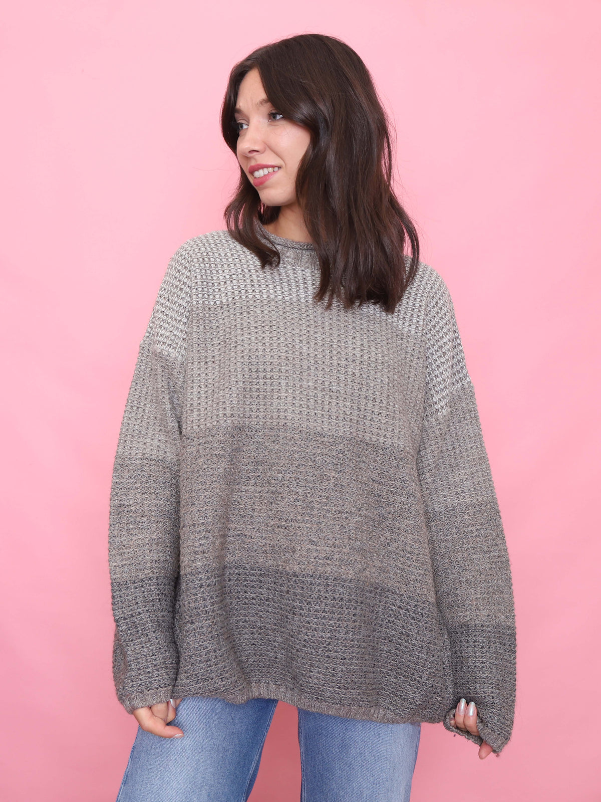 Model wearing a vintage grey ombre knit jumper with textured pattern and relaxed fit


