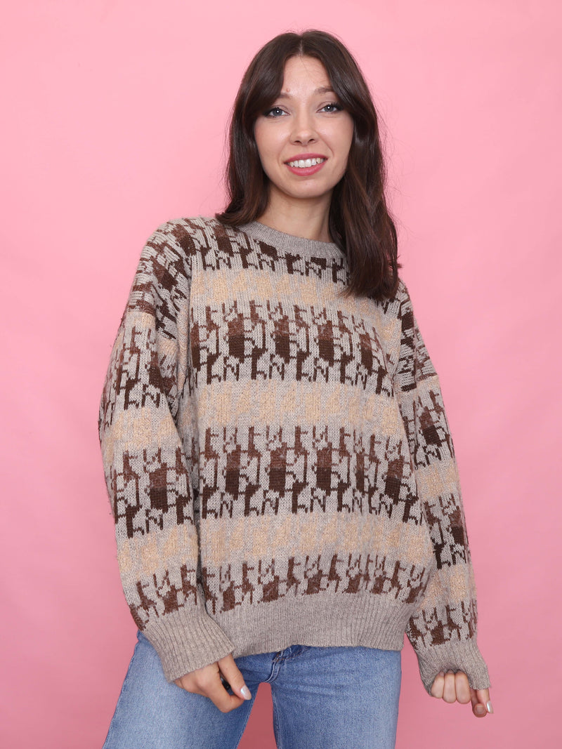 Woman wearing a vintage beige jumper with brown deer knit pattern, cosy autumn aesthetic


