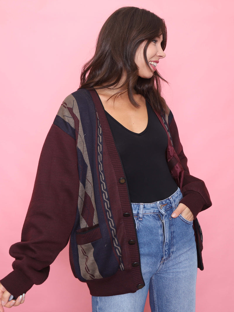 Model wearing a vintage maroon knit cardigan jacket with abstract patterned panels and front pockets – retro unisex autumn layering piece