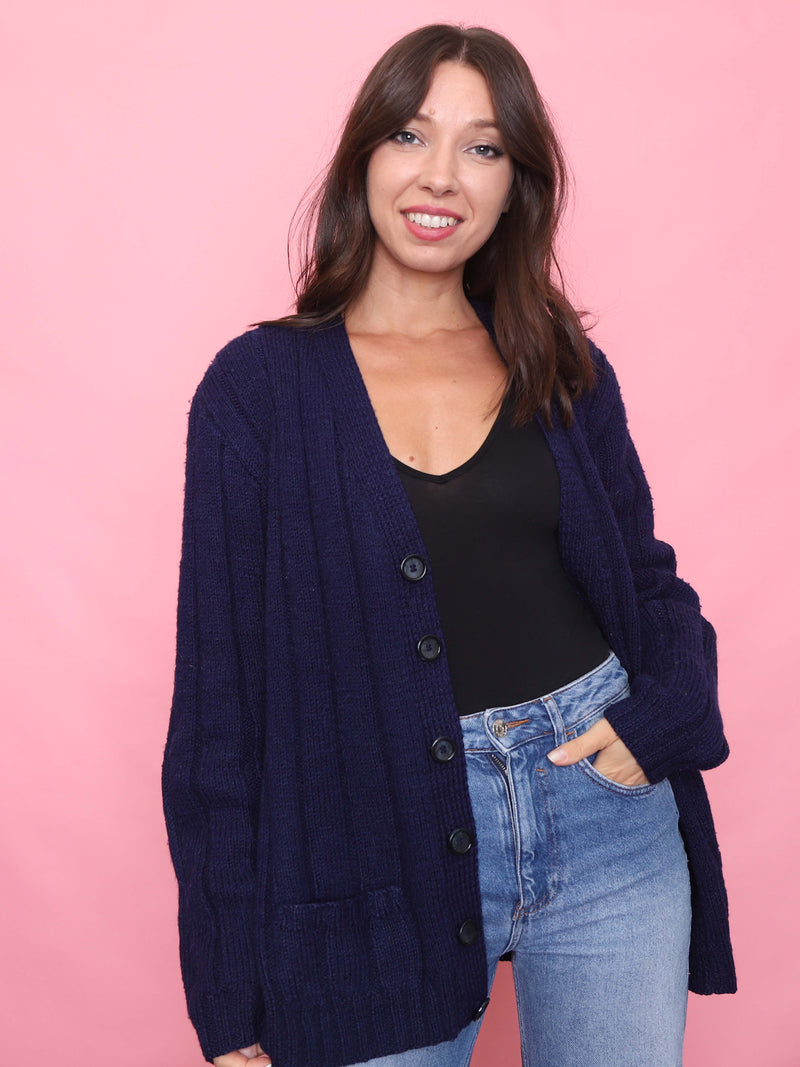 Model wearing vintage navy ribbed knit cardigan with button-up front and pockets

