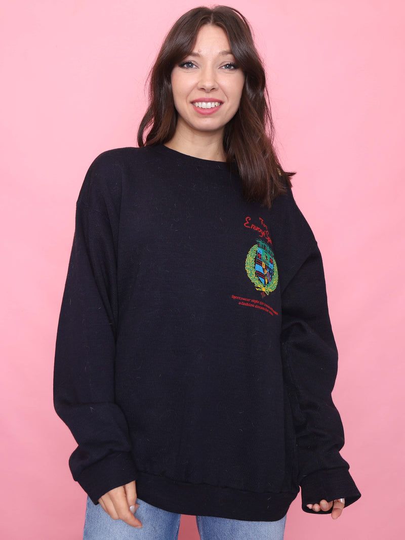 Model wearing vintage navy crest knit jumper with gold shoulder buttons, styled for cosy autumn fashion

