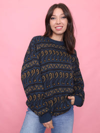 Woman wearing a navy and mustard patterned vintage jumper styled for cosy autumn weather

