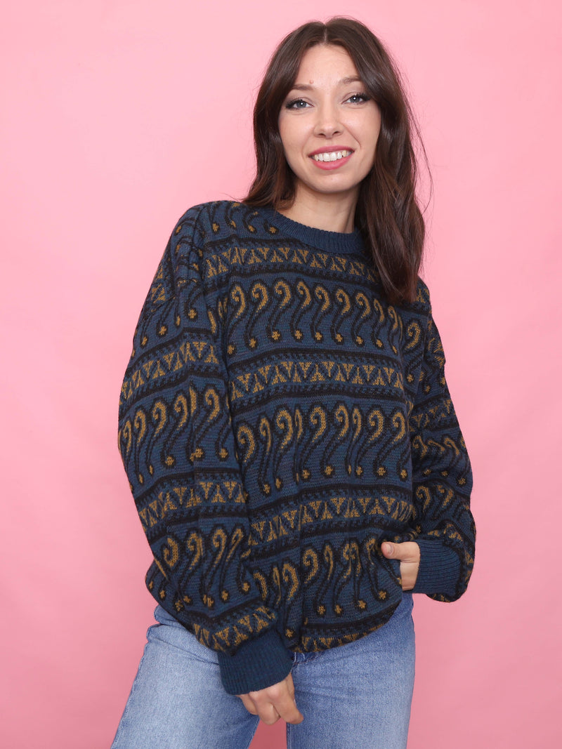 Woman wearing a navy and mustard patterned vintage jumper styled for cosy autumn weather

