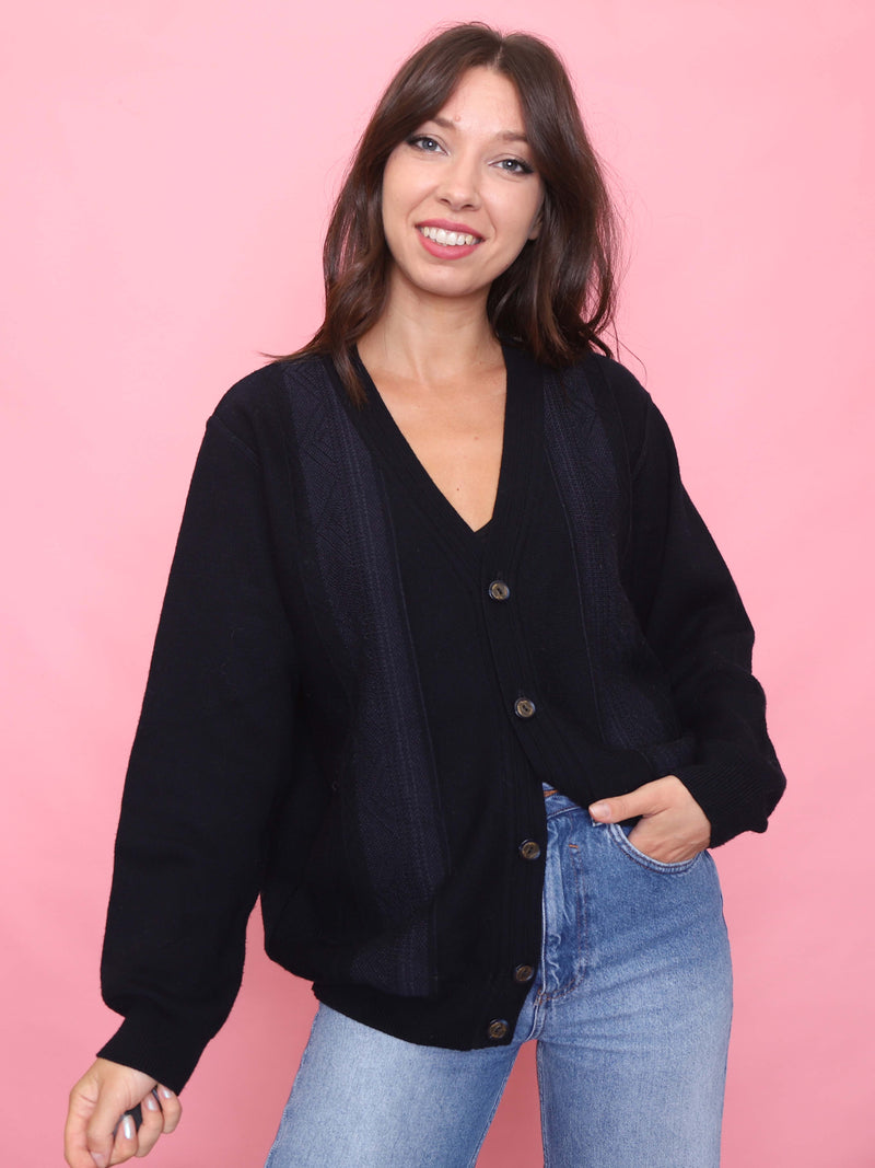 Model wearing a vintage navy button-up knit cardigan with subtle tonal pattern, relaxed fit, and ribbed trim.