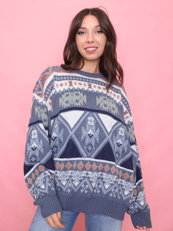 Model wearing a vintage blue Nordic-style patterned knit jumper with geometric design

