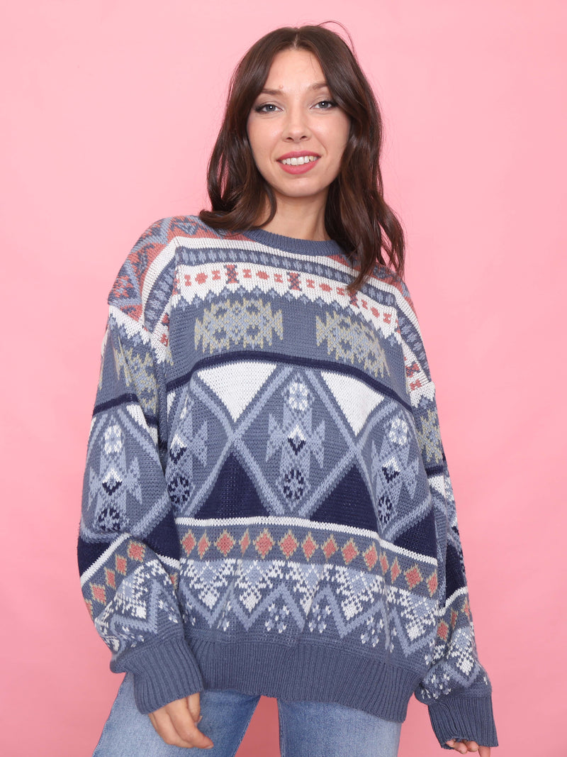 Model wearing a vintage blue Nordic-style patterned knit jumper with geometric design


