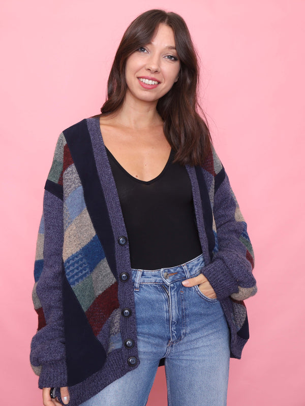 Model wearing vintage multicolour patchwork knit cardigan jacket with navy trim
