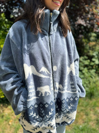 Snuggle into this vintage polar fleece jacket featuring a forest bear scene. The ultimate cosy zip-up layer for winter and autumn adventures.