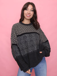 Woman wearing a charcoal and grey vintage pure new wool jumper with a cosy textured knit

