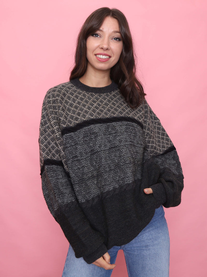 Woman wearing a charcoal and grey vintage pure new wool jumper with a cosy textured knit

