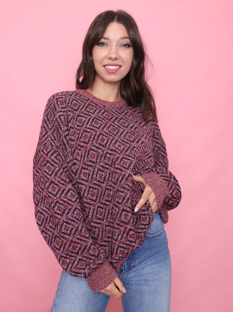 Woman wearing a vintage red and navy diamond knit jumper styled for cosy autumn fashion

