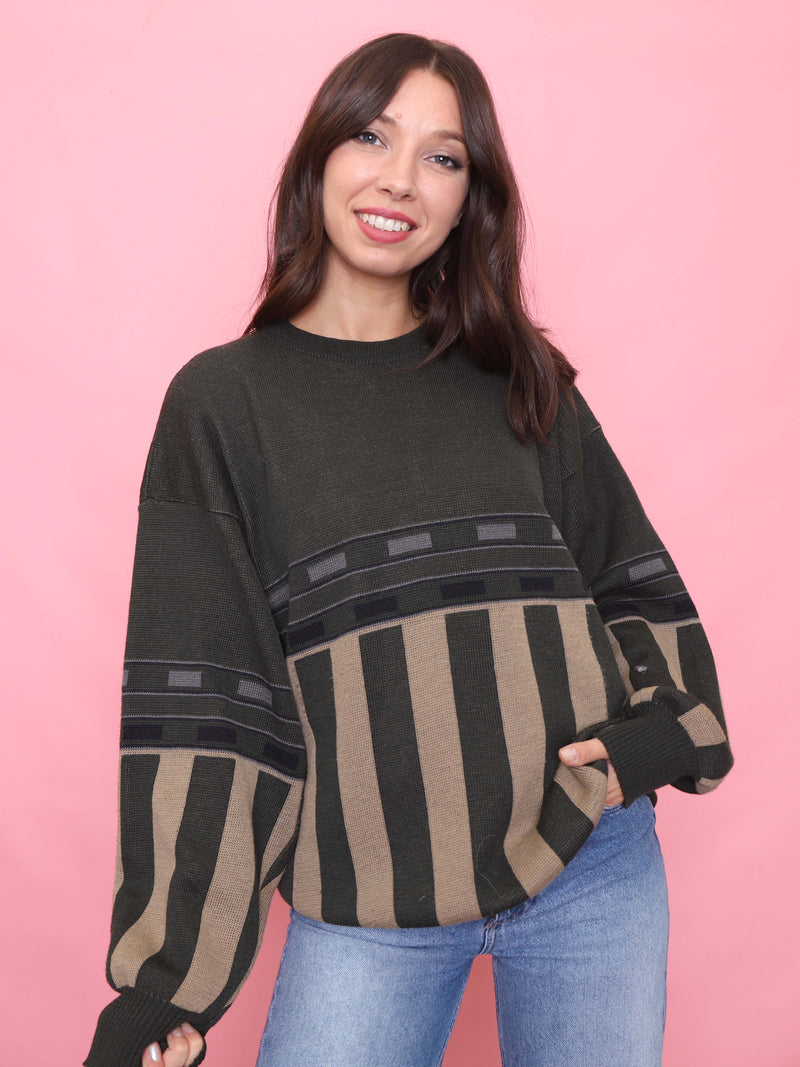 Model wearing a vintage green and tan striped jumper with oversized unisex fit and ribbed details.

