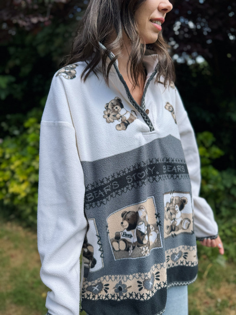 Model wearing a vintage 1/4 button fleece jacket with teddy bear patchwork and neutral colours