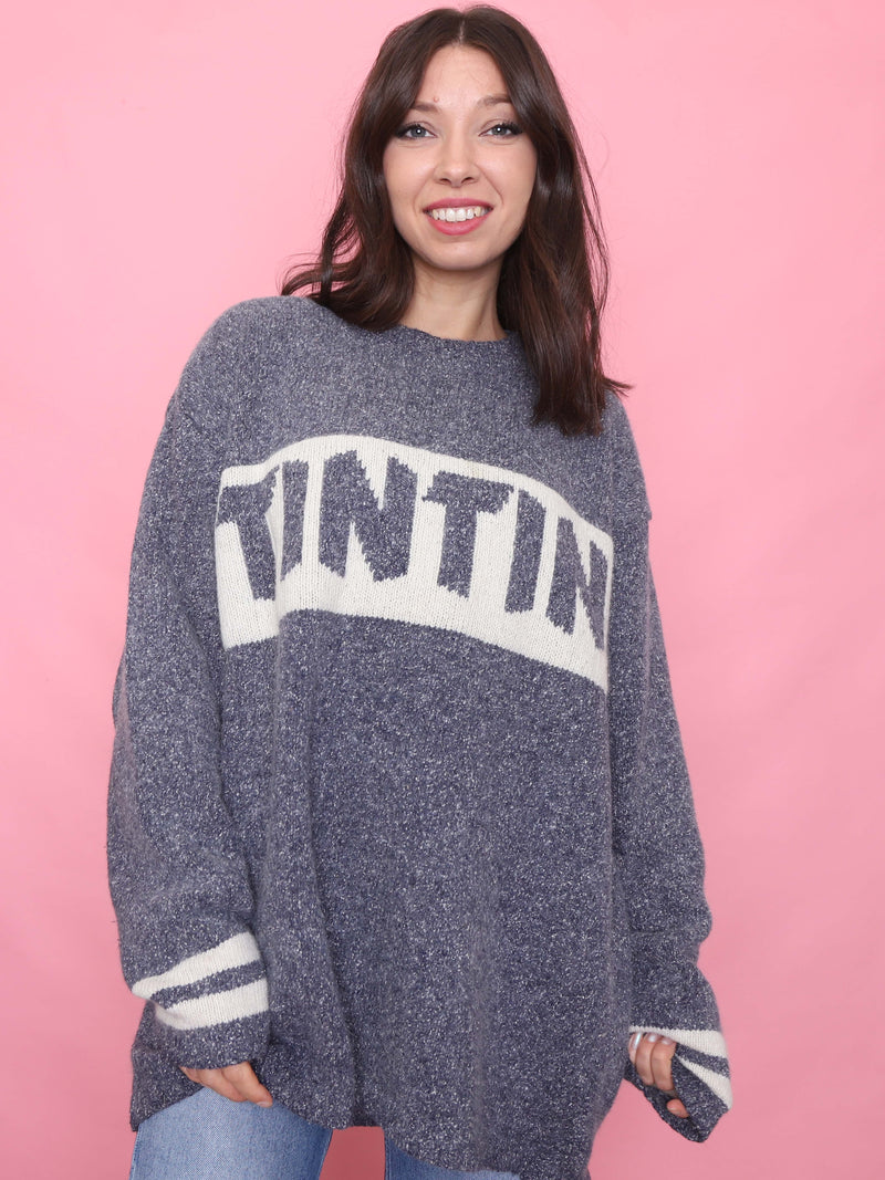 Model wearing oversized vintage Tintin jumper in grey and cream, cosy autumn knit with retro cartoon style