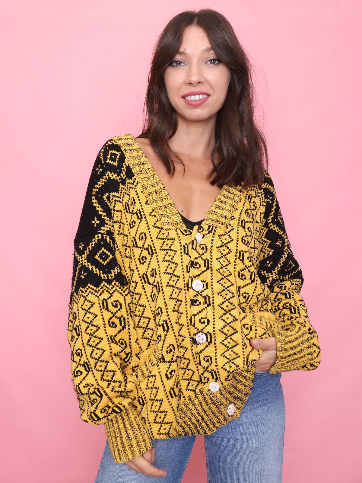 Model wearing vintage yellow and black button-up cardigan with geometric pattern

